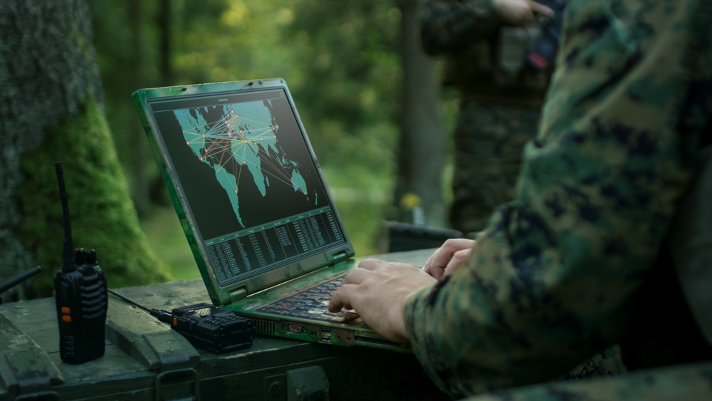 Military Operation in Action, Soldiers Using Military Grade Laptop Targeting Enemy with Satellite. In the Background Camouflaged Tent on the Forest